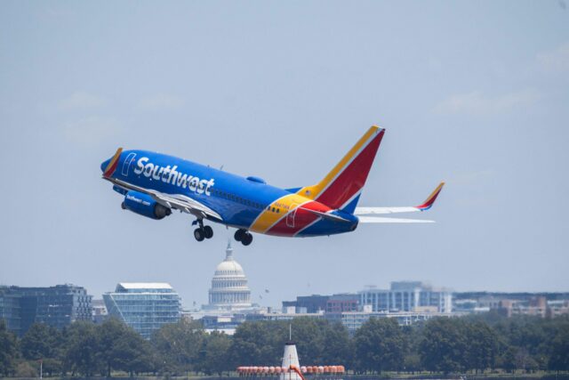 Southwest Airlines Boeing 737 flying over skyline with US Capitol visible during daytime. Washington DC