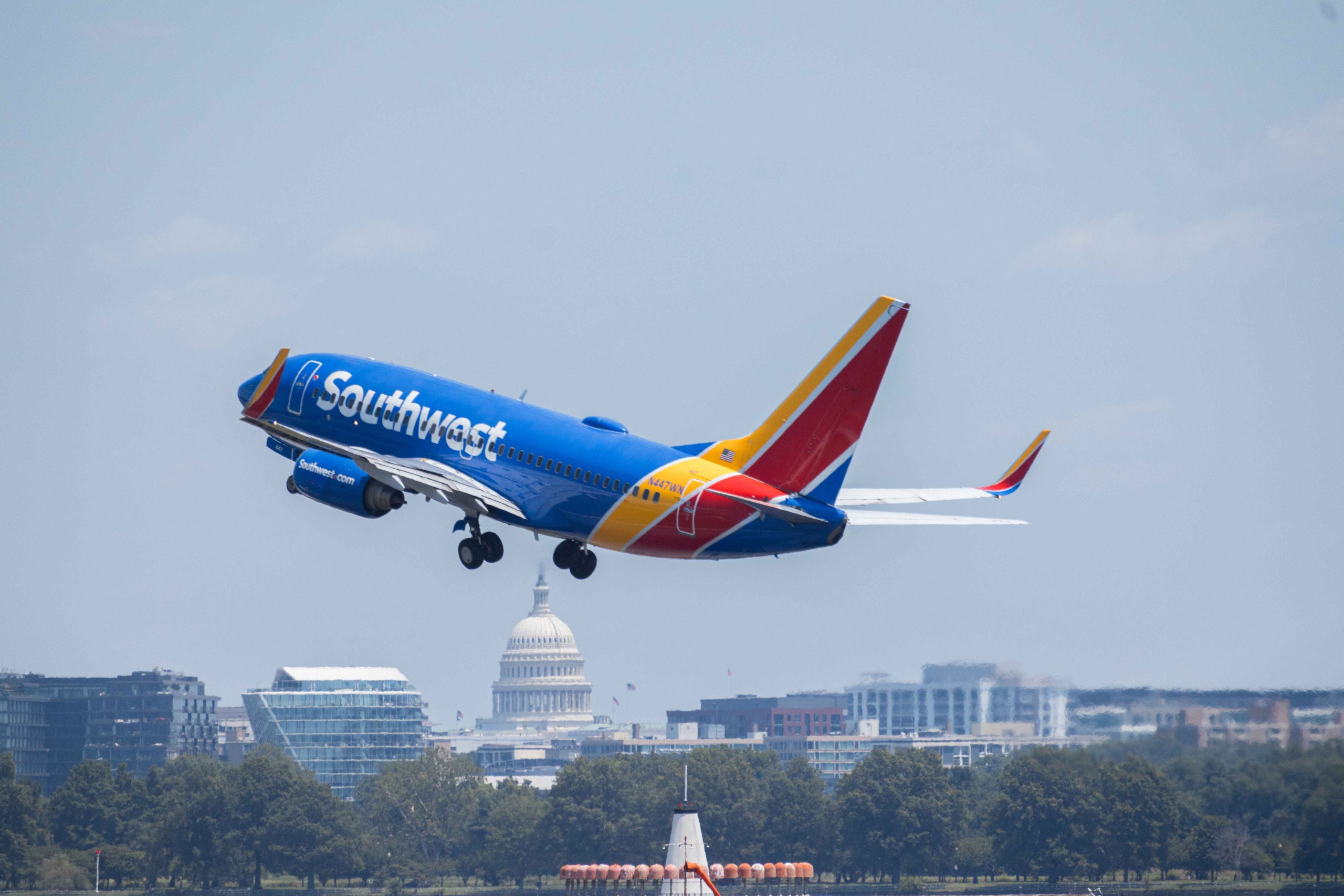 Southwest Airlines Boeing 737 flying over skyline with US Capitol visible during daytime. Washington DC