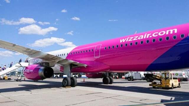 Gdansk, Poland. June 09, 2019. Wizz Air aircraft during passenger boarding on airport apron with ground service vehicles and terminal building in background.