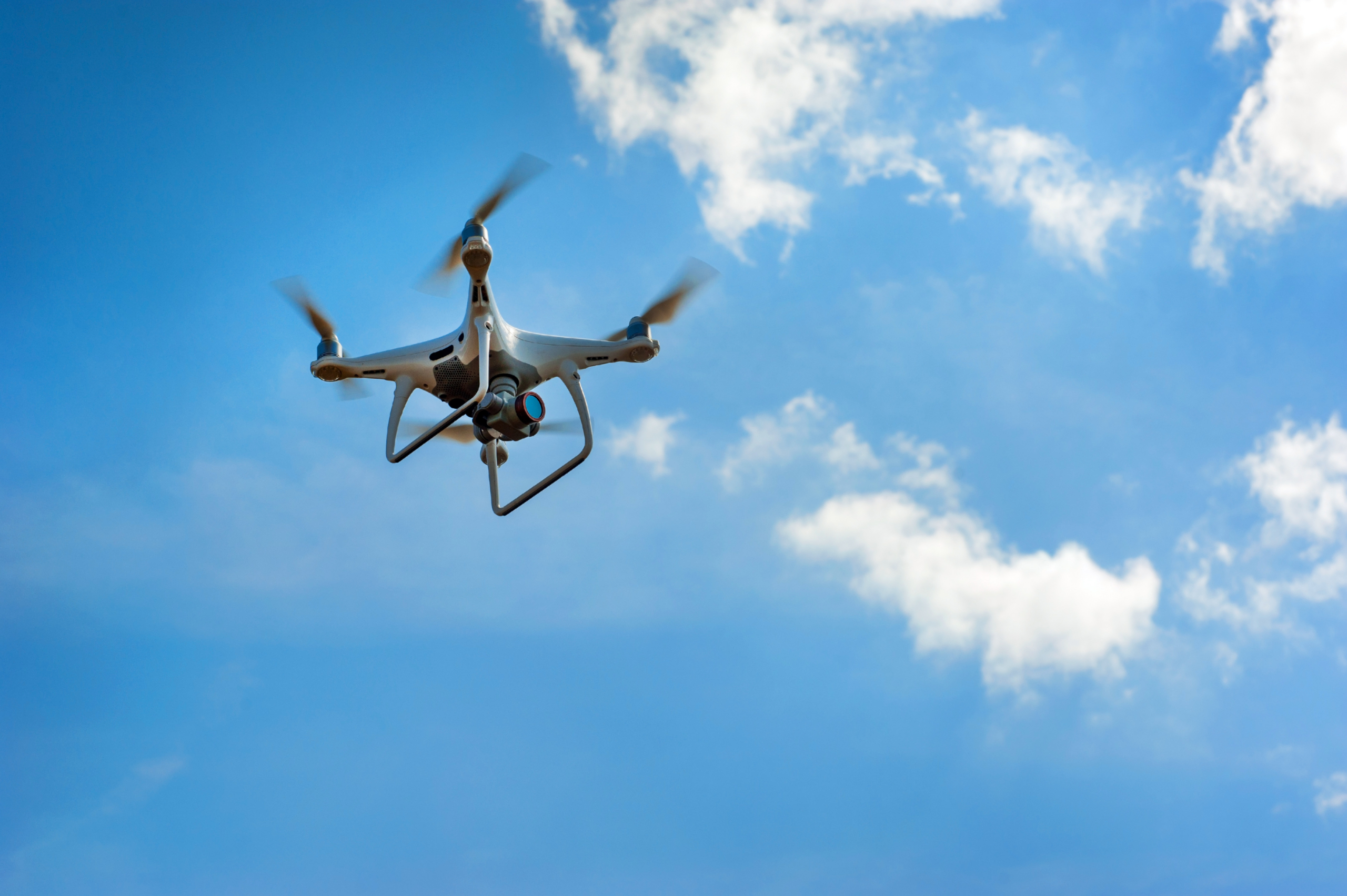 Drone flying in blue sky