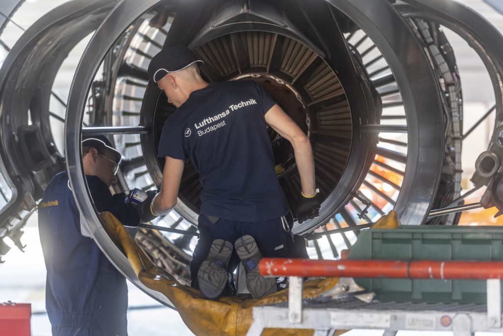 Lufthansa Technik engineers working on an engine
