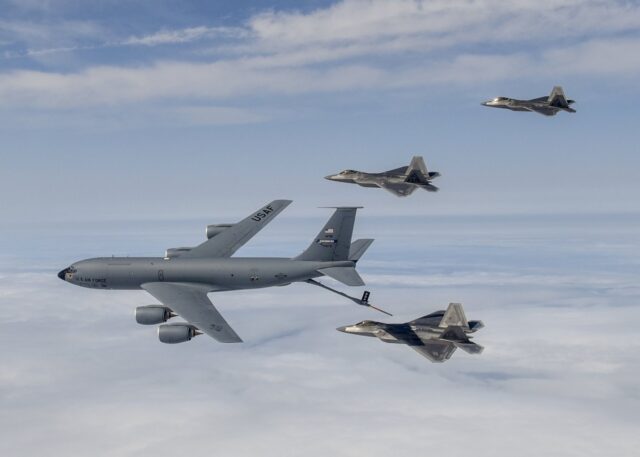 US Air Force KC-135 tanker refuels an F-22 Raptor mid air