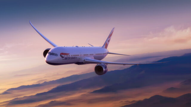 Boeing 787-10 in flight above the mountains at sunset.
