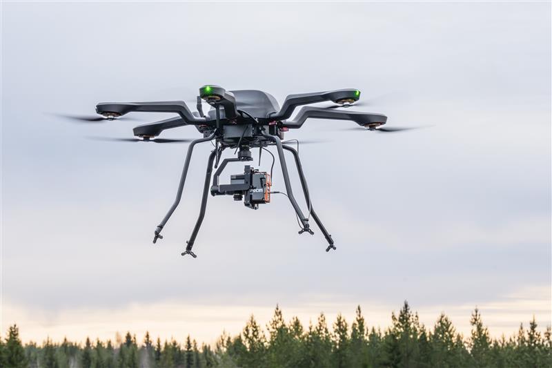 A drone flying at VTT’s testing site is equipped with a hyperspectral camera.