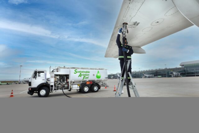 Technician is refueling aircraft with Sustainable Aviation Fuel (SAF) at the airport.