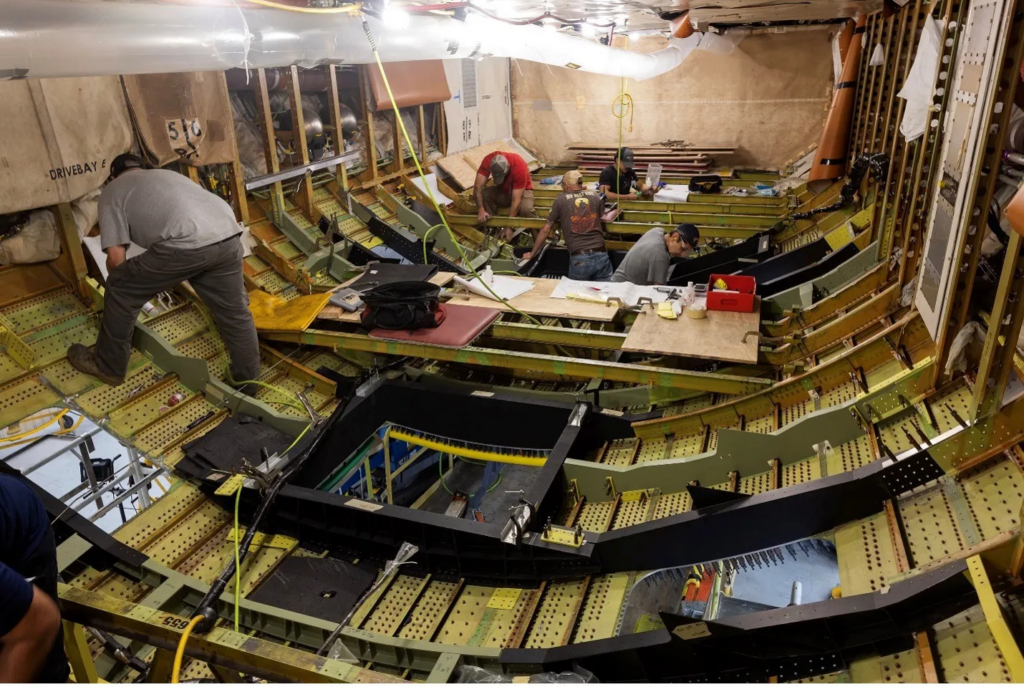 L3Harris personnel install viewports in the NASA 777-200ER's cargo bay that will be used to house advanced scientific instruments. Image: L3Harris