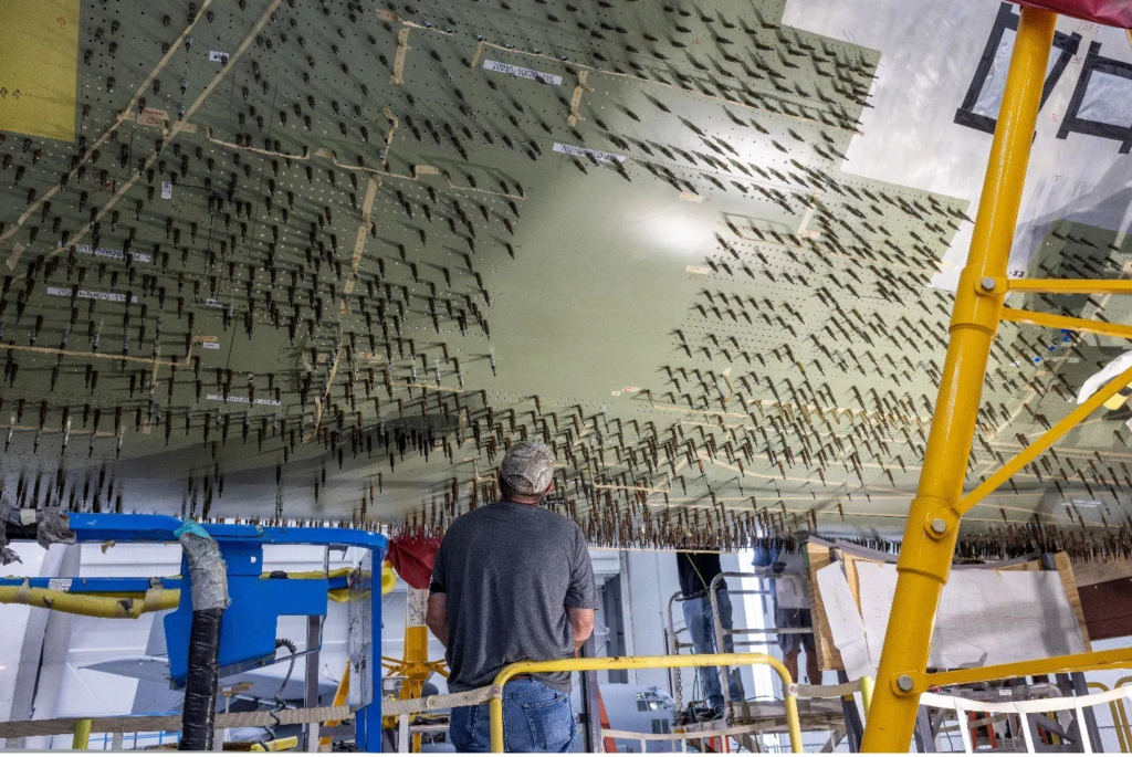Temporary fasteners are used to map out hole patterns through four layers of reinforcement. Nearly 35,000 precision holes are drilled into the belly of NASA's new 777-200ER aircraft. Image: L3Harris