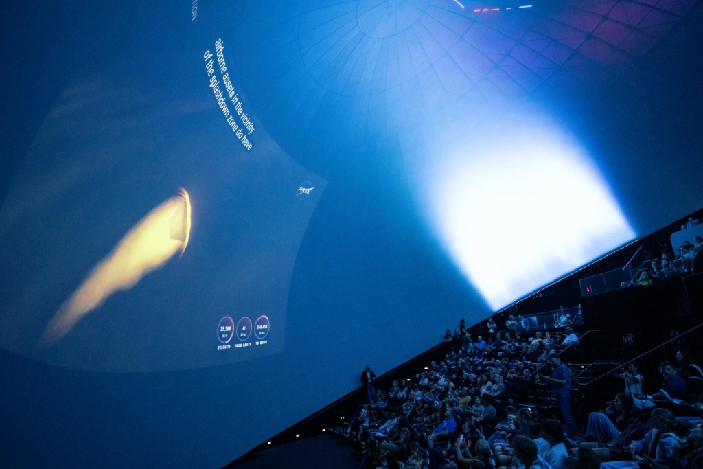 Artemis II returns as people watch on from a nASA visitor centre