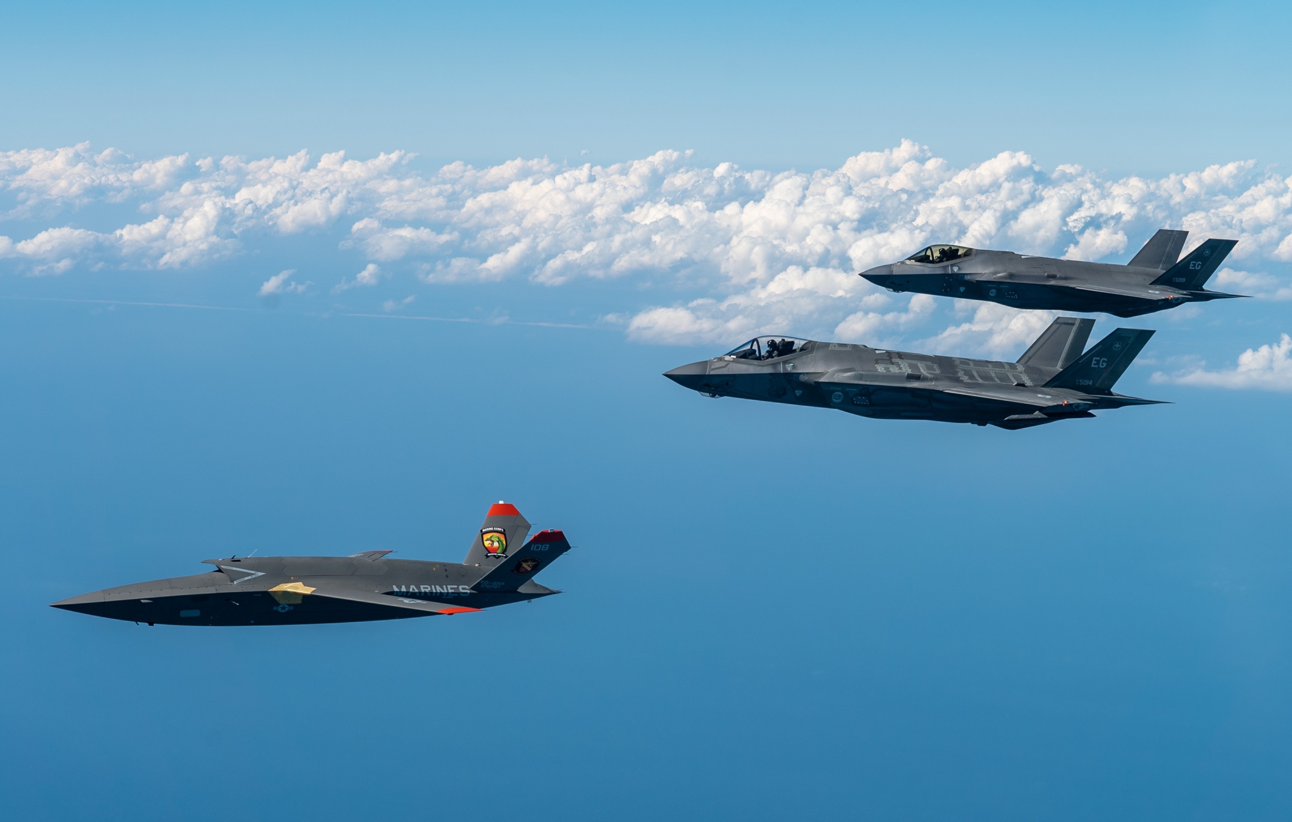 One of the USMC's RATO-configured XQ-58A Valkyrie prototypes is seen in formation with a pair of USAF-operated F-35A Lightning IIs during a test mission from Eglin AFB, Florida, on 23 February 2024. Image: USAF/Master Sgt John McRell
