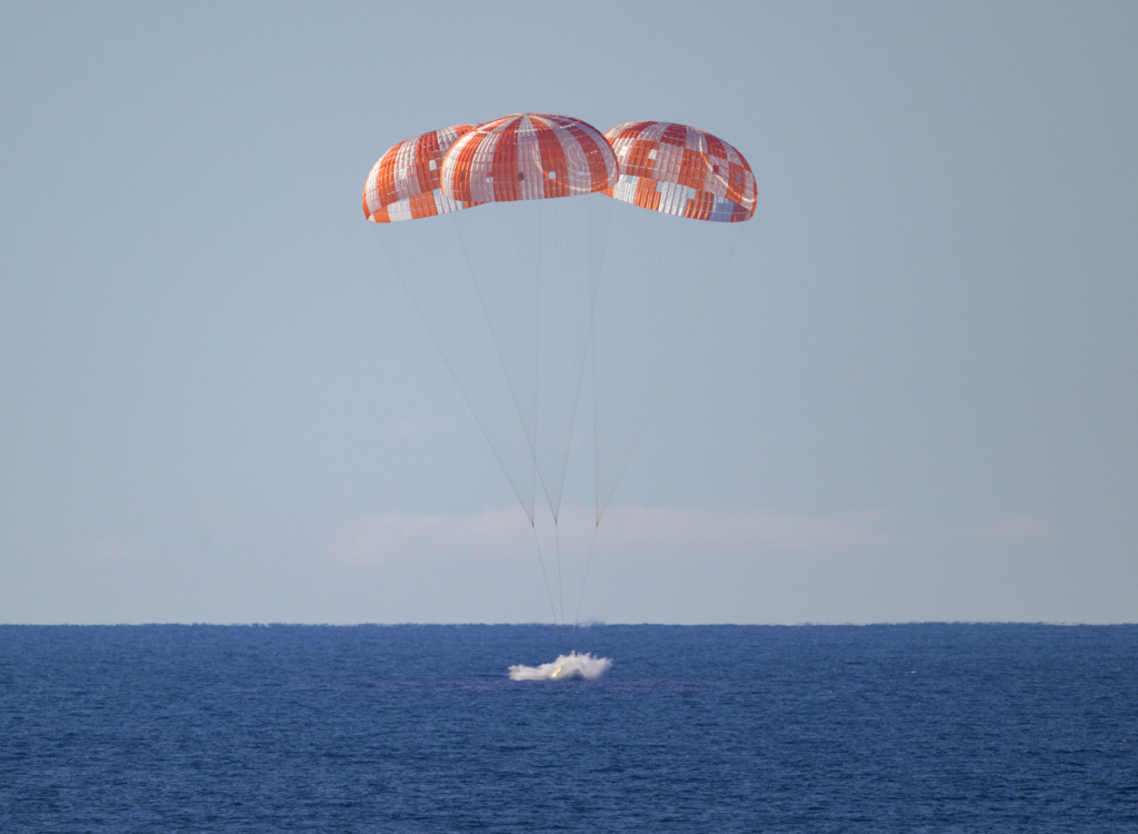 NASA’s Orion spacecraft with Artemis II crewmembers NASA astronauts Reid Wiseman, commander; Victor Glover, pilot; Christina Koch, mission specialist; and CSA (Canadian Space Agency) astronaut Jeremy Hansen, mission specialist aboard is seen as it lands in the Pacific Ocean off the coast of California, Friday, April 10, 2026. NASA’s Artemis II mission took Wiseman, Glover, Koch, and Hansen on a 10-day journey around the Moon and back to Earth. Following a splashdown at , NASA, U.S. Navy, and U.S. Air Force teams are working to bring the crewmembers and Orion spacecraft aboard USS John P. Murtha.  Photo Credit: (NASA/Bill Ingalls)