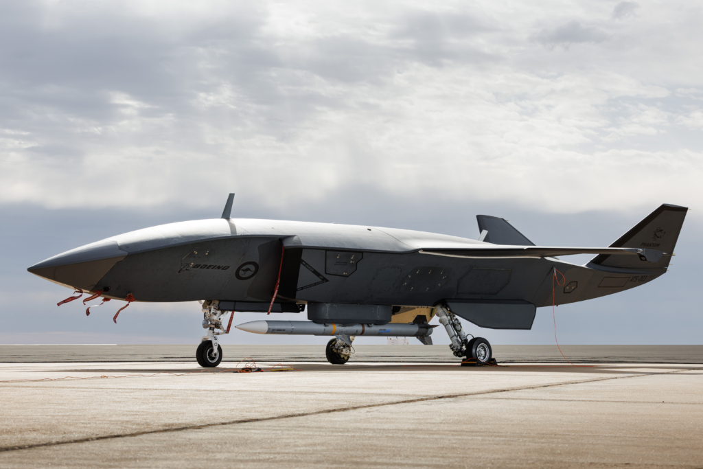 An MQ-28 is seen loaded with an AIM-120 AMRAAM during Trial Kareela 25-4 at RAAF Base Woomera, South Australia, on 8 December 2025. This image offers a good representation of the size of an AIM-120 compared with the Ghost Bat. Image: Australian Department of Defence/AC Ivan Smotrov