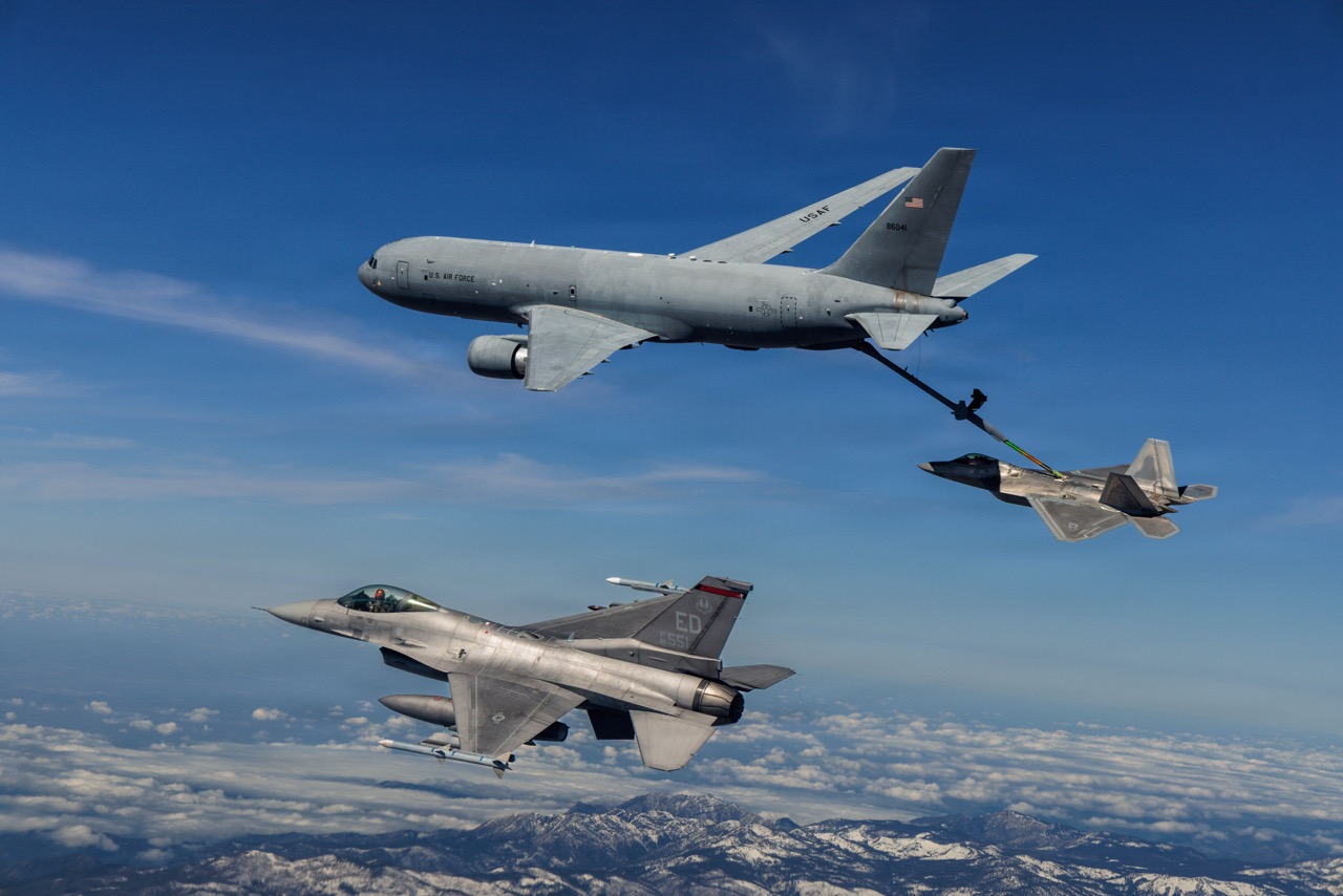 A KC-46 Pegasus assigned to the 418th Flight Test Squadron, Global Reach Combined Test Force, refuels an F-22 Raptor assigned to the 411th Flight Test Squadron, Air Dominance Combined Test Force while an F-16 assigned to the 416th Flight Test Squadron, Airpower Foundations Combined Test Force, awaits a turn over the Mojave Desert on March 3, 2026. Partnerships between the Combined Test Forces at Edwards helps expedite critical capability for the warfighter by leveraging multiple program portfolios in tandem. In this scenario, the F-16 aircraft was operating as a target for key F-22 Raptor test points while the KC-46 was able to collect additional data for aerial refueling efforts. (Courtesy photo)