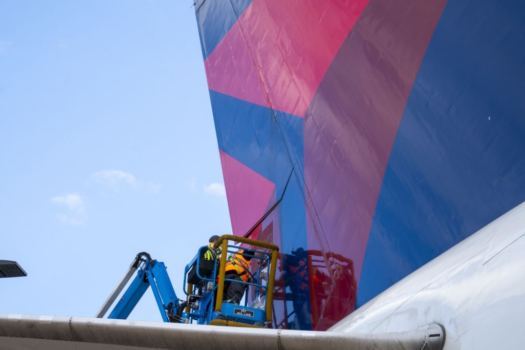 MAKO personnel install Flightfilm on the fuselate of a Delta Air Lines aircraft