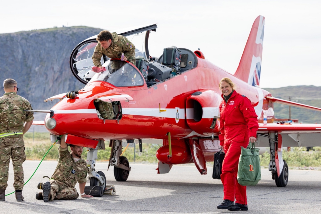 Support crews check over the Hawk T1 during a stopover in Greenland