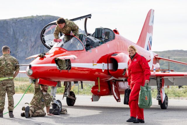 Support crews check over the Hawk T1 during a stopover in Greenland