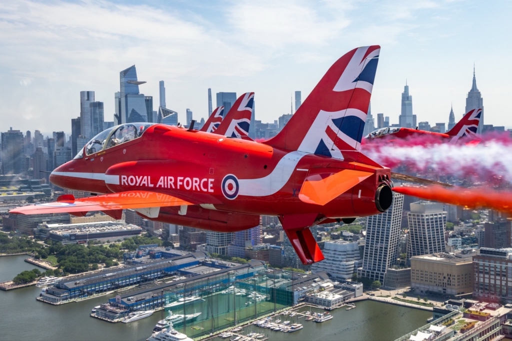 The Royal Air Force Aerobatic Team, The Red Arrows fly down the Hudson river in New York streaming the Red, White and Blue.