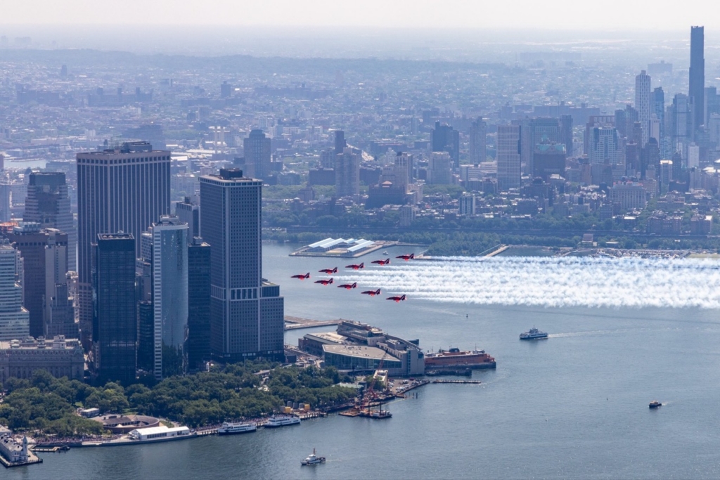 The Royal Air Force Aerobatic Team, The Red Arrows fly down the Hudson river in New York streaming the Red, White and Blue.