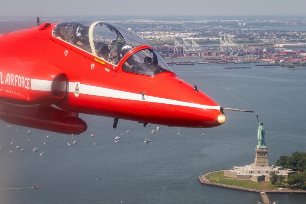 The Royal Air Force Aerobatic Team, The Red Arrows fly down the Hudson river in New York streaming the Red, White and Blue.