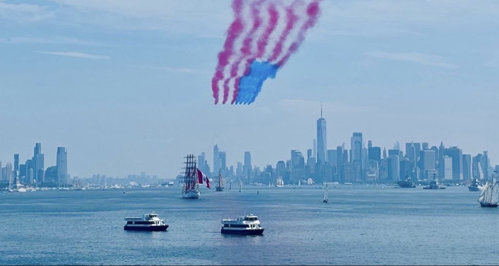 The Royal Air Force Aerobatic Team, The Red Arrows fly down the Hudson river in New York streaming the Red, White and Blue. 