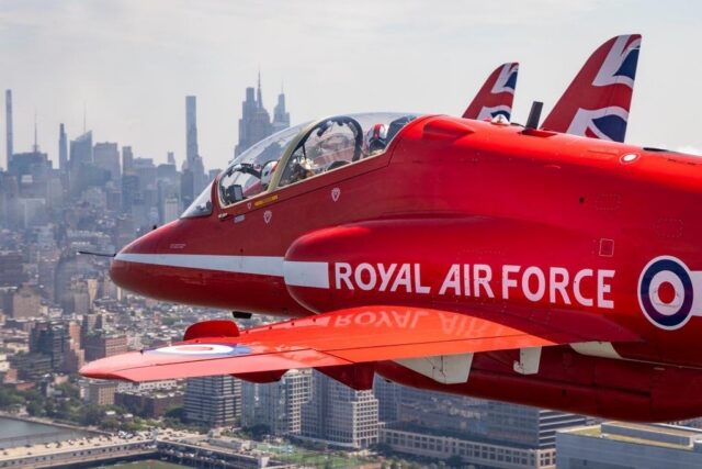 The Royal Air Force Aerobatic Team, The Red Arrows fly down the Hudson river in New York streaming the Red, White and Blue.