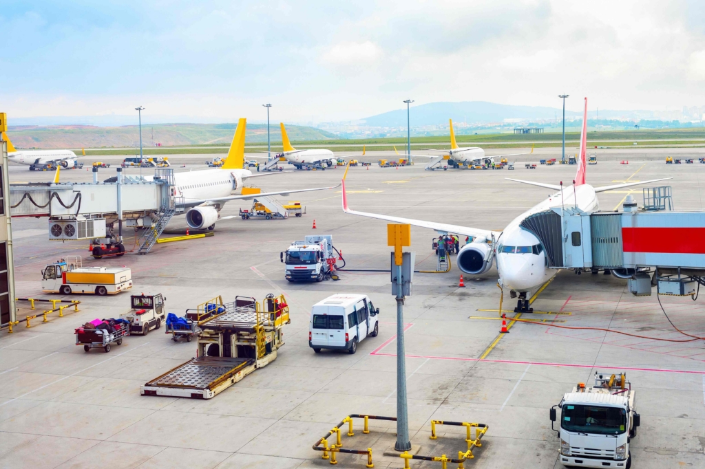 Aerial view of Istanbul International Airport airfield with planes, gangways, trucks and service equipment, Turkey