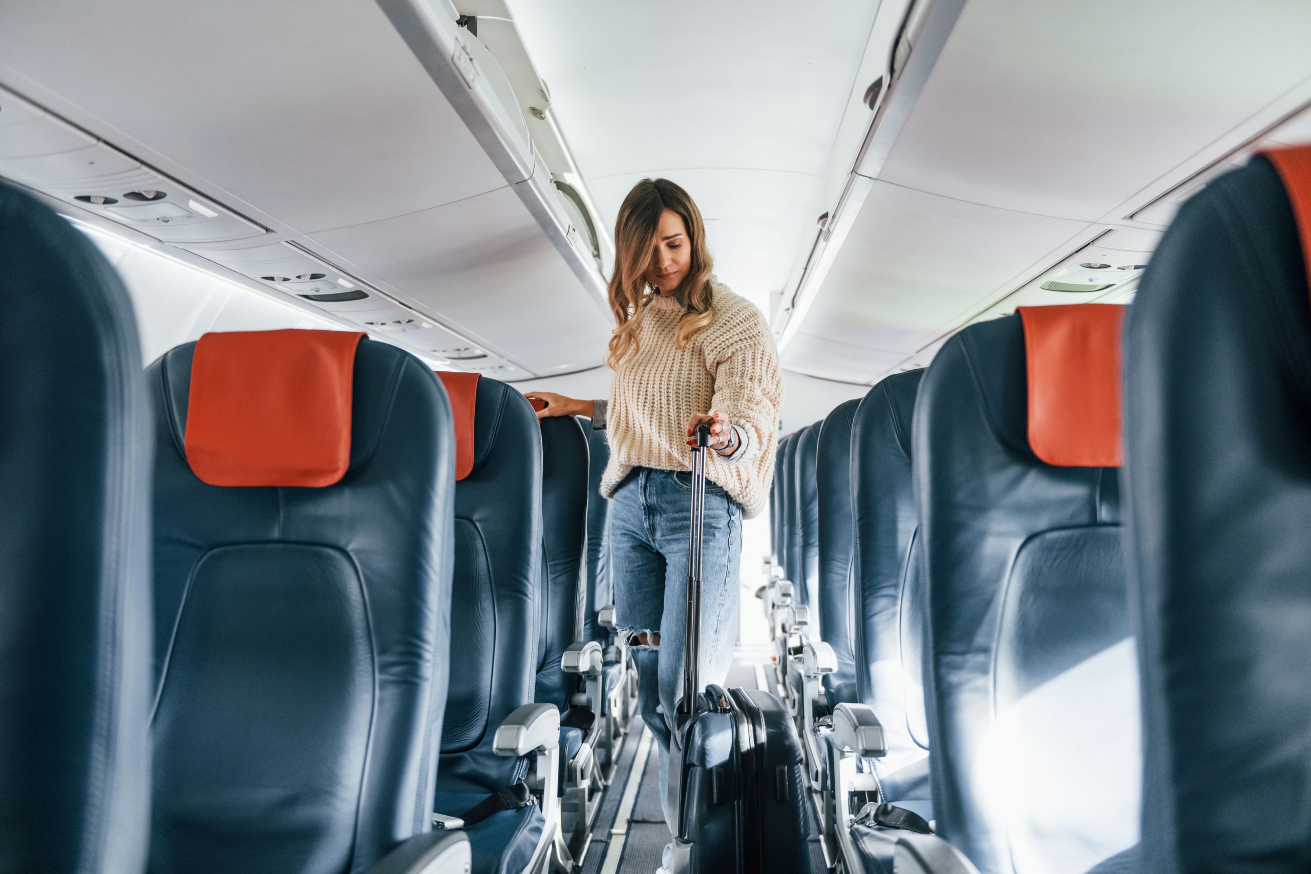 Woman with bag on passenger aircraft
