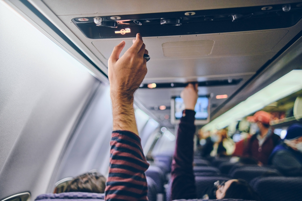 Aircraft passengers adjust their air vents