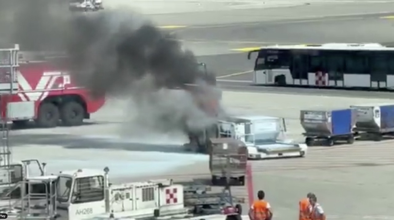 Baggage cart on fire at Malpensa Airport.