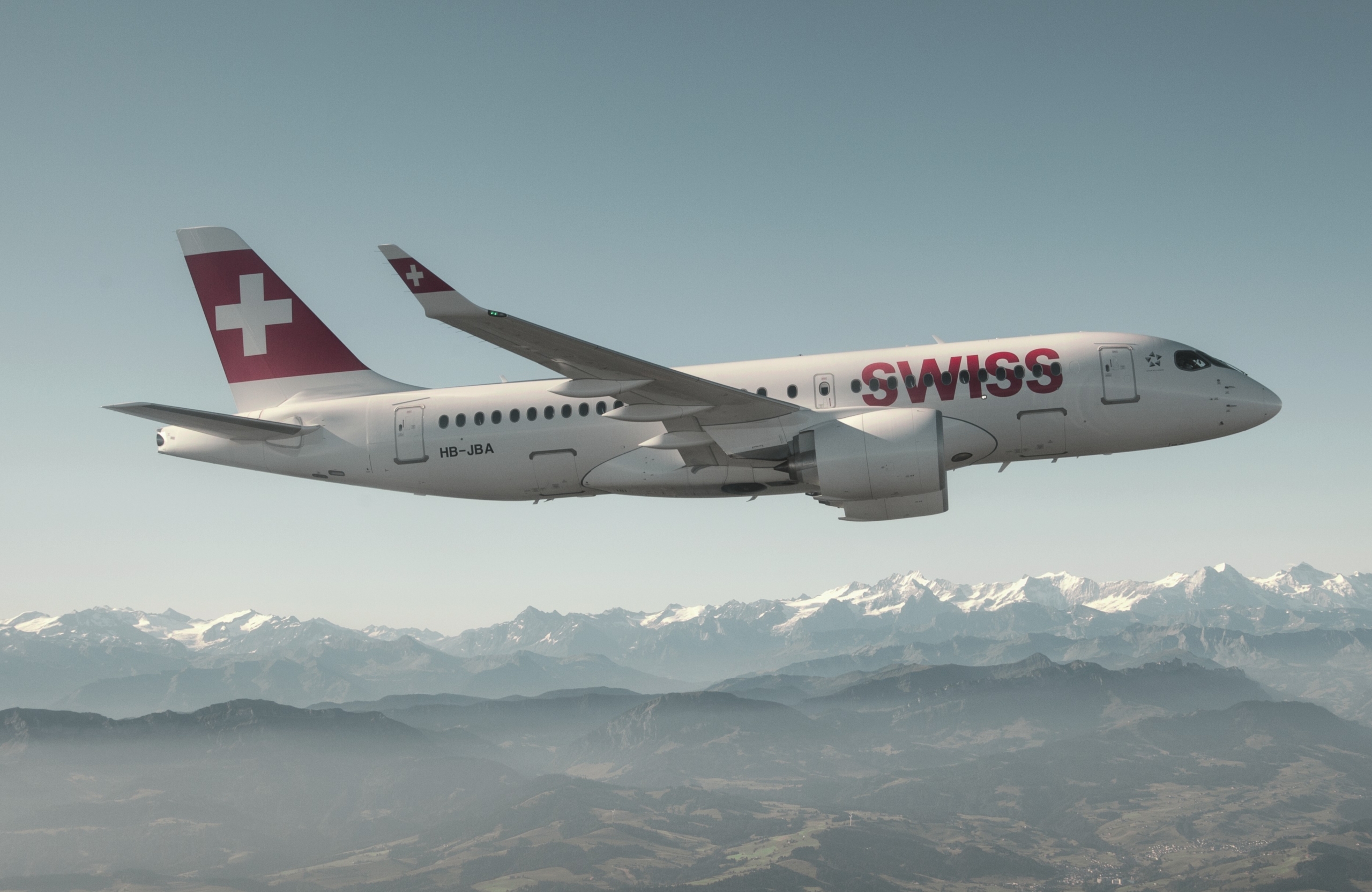 A SWISS-operated Airbus A220-100 (registration ZB-JBA) in flight. Image: Swiss International Air Lines Ltd