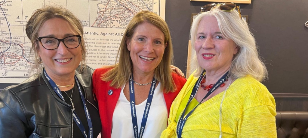 Lynda Coffman (wearing black) Women in Aviation International networking with other women at FIA 2026