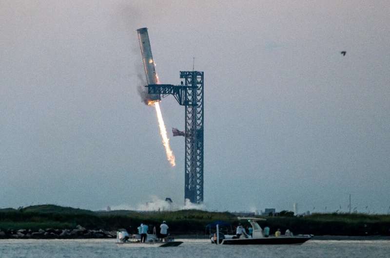 Starship megarocket booster caught by SpaceX's 'chopsticks'
