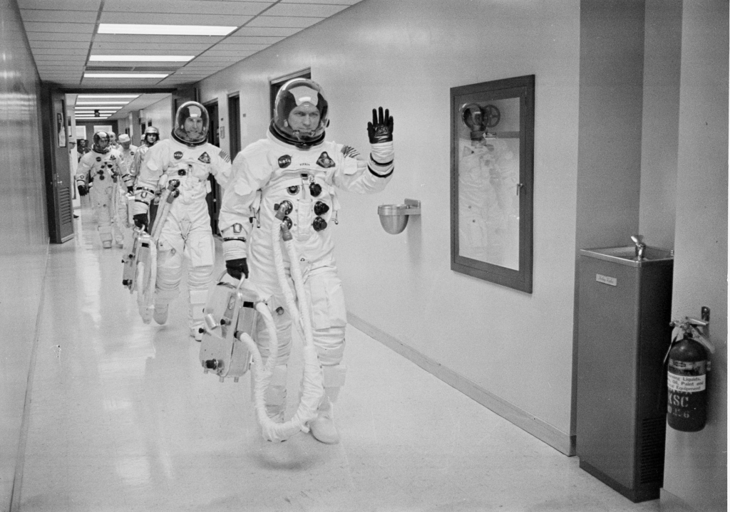 Apollo 8 Astronaut and commander Frank Borman leads the way as he and James Lovell, Command Module (CM) pilot; and William Anders, Lunar Module (LM) Pilot head out to the launch pad for the historical first manned Apollo mission to travel to the lunar vicinity, and first manned mission launched via the Saturn V vehicle.