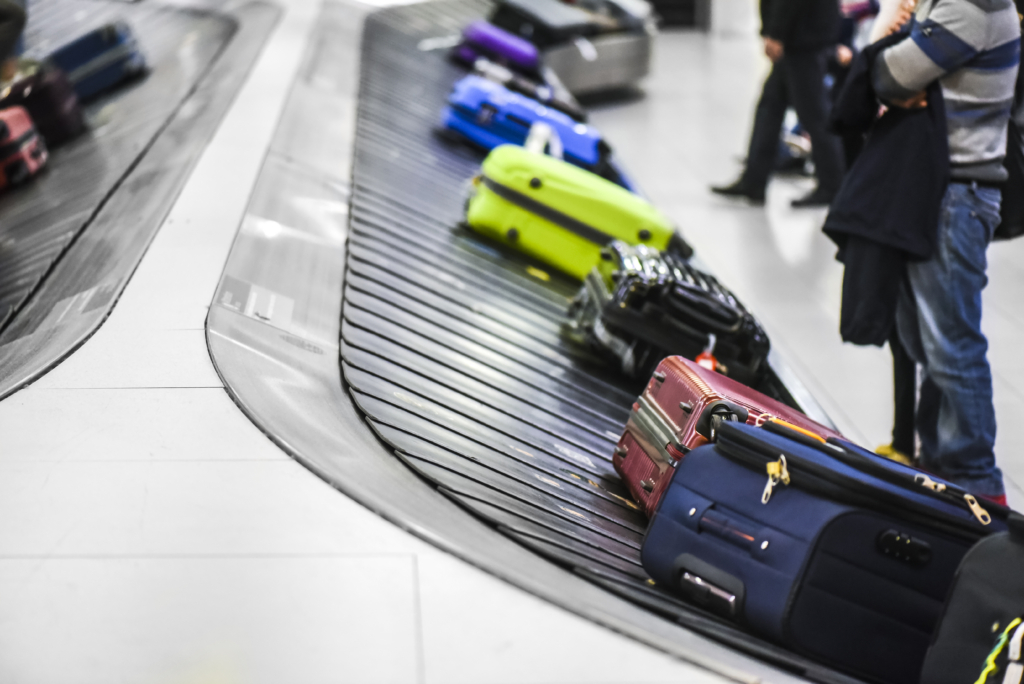 Baggage handling and suitcases or luggage on the conveyor belt at the airport