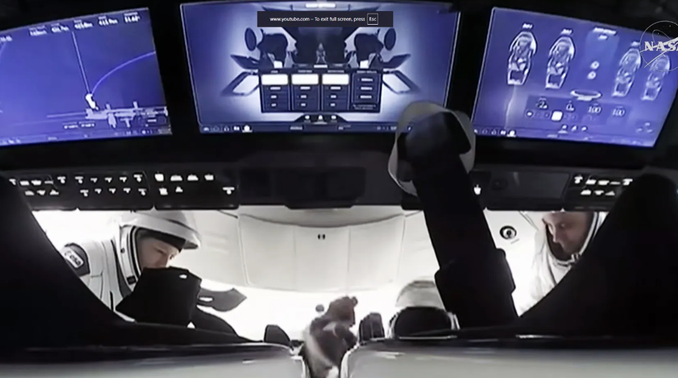 ESA astronaut Sophie Adenot (left) and Roscosmos cosmonaut Andrey Fedyaev (right) are inside the SpaceX Dragon spacecraft preparing to undock from the International Space Station.