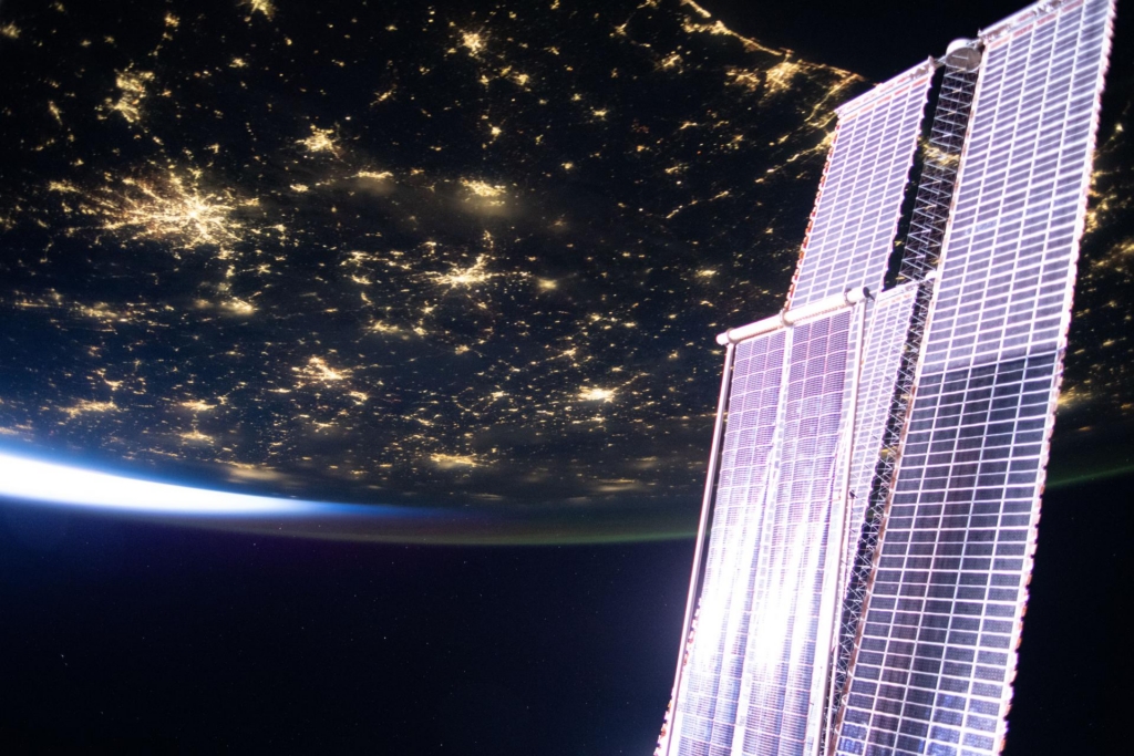  a set of the orbital outpost’s main solar arrays augmented by a smaller set of roll-out solar arrays.