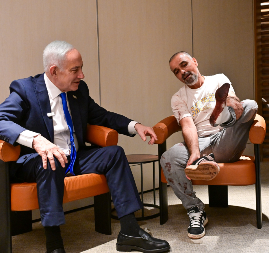 Prime Minister Benjamin Netanyahu at his Ben-Gurion International Airport meeting with Yaniv Hayun, the passenger who broke into the cockpit on the flight from Dubai to Israel/